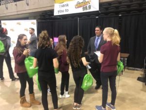 Group of WYCC teenage girls speak to man in business suit